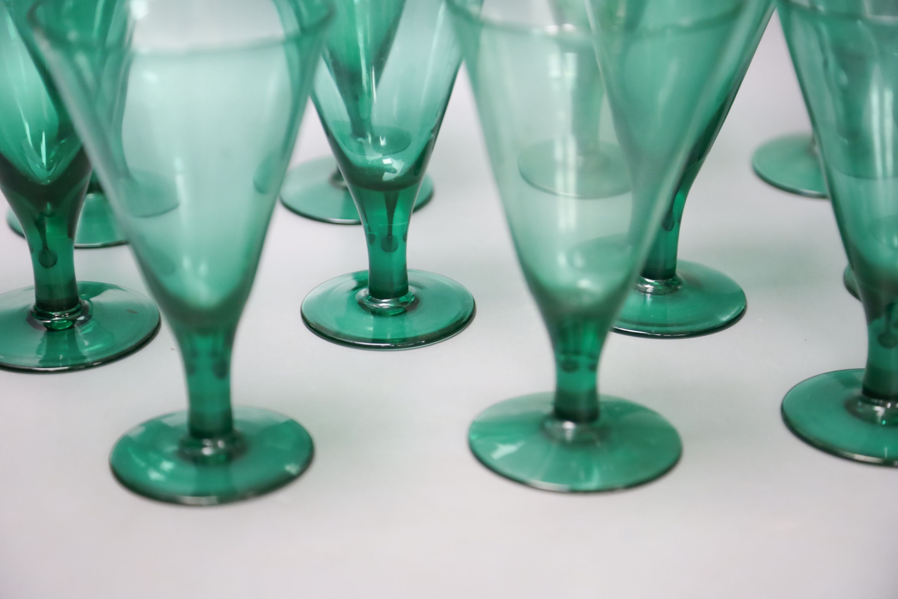 Eleven green wine glasses